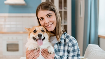 Person holding a smiling dog.
